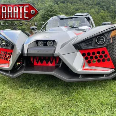 A black and red Slingshot with monster teeth design