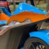 The back hood of a blue and orange Slingshot model