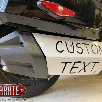 A metal vehicle part with custom text